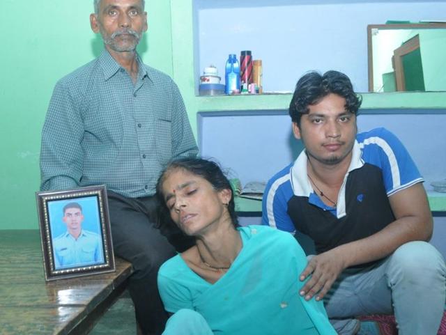 Family members with a photo of one of the missing IAF personnel. (HT Photo) Family members with a photo of one of the missing IAF personnel. (HT Photo)
