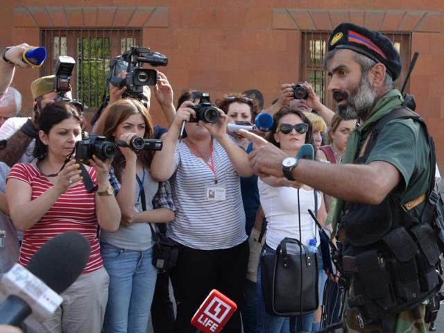 An armed man speaks to the press after pro-opposition gunmen locked in a week-long hostage standoff with Armenian authorities released the final four police officers held captive in Yerevan. (AFP) An armed man speaks to the press after pro-opposition gunmen locked in a week-long hostage standoff with Armenian authorities released the final four police officers held captive in Yerevan. (AFP)