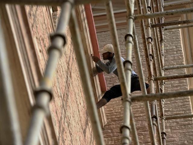 A worker fixes wall of the church. (Gurinder Osan/HT Photo) 