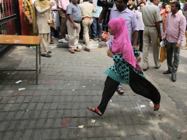 A NEET-2 aspirant makes a dash at the gates of the examination centre before it gets closed in Jaipur, Rajasthan on Sunday. (Himanshu Vyas/ Hindustan Times)