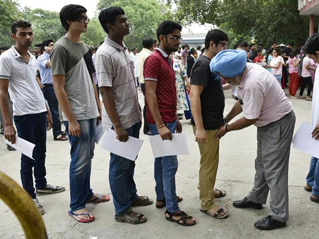 Candidates being frisked at Guru Harkrishan Public School, Vasant Vihar in New Delhi on Sunday. (Arvind Yadav / Hindustan Times)