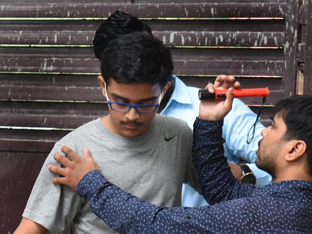 A student is being frisked outside the examination centre at Kerala School in New Delhi on Sunday. (Sushil Kumar/ Hindustan Times)