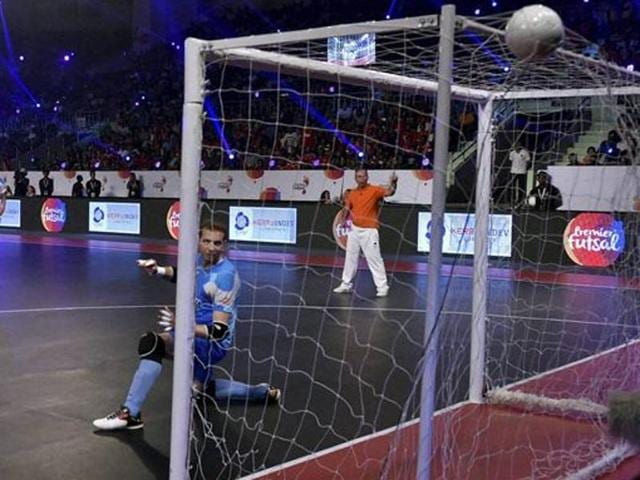 Kochi5s futsal player Deives Moraes (Purple) hits first goal against Mumbai 5s (Blue). (PTI Photo) Kochi5s futsal player Deives Moraes (Purple) hits first goal against Mumbai 5s (Blue). (PTI Photo)