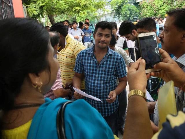 An aspirant of NEET-2 gets a photograph taken by his parents as he enters the examination center in Jaipur, Rajasthan on Sunday.(Himanshu Vyas/ Hindustan Times)