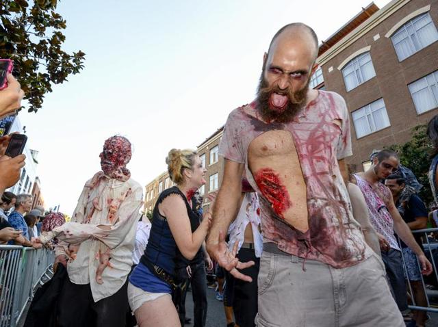 Zombies drag their half-dead bodies down the Fifth Avenue as they take part in the Zombie Walk. (Denis Poroy/Invision/AP) Zombies drag their half-dead bodies down the Fifth Avenue as they take part in the Zombie Walk. (Denis Poroy/Invision/AP)