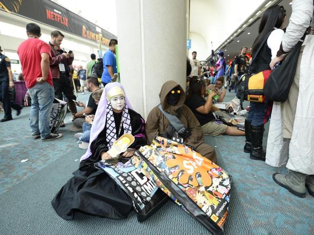 Fans dressed as Star Wars characters take a break on the floor of the convention center. (Denis Poroy/Invision/AP) Fans dressed as Star Wars characters take a break on the floor of the convention center. (Denis Poroy/Invision/AP)
