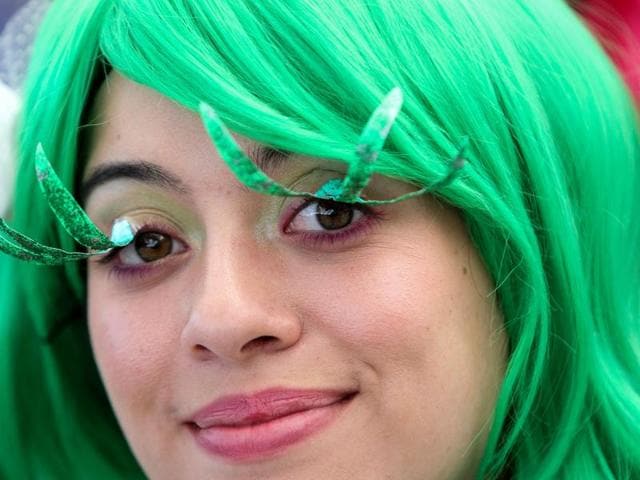 A woman dressed as the character Disgust from the Inside Out movie shows off her long eye lashes. (AFP) A woman dressed as the character Disgust from the Inside Out movie shows off her long eye lashes. (AFP)