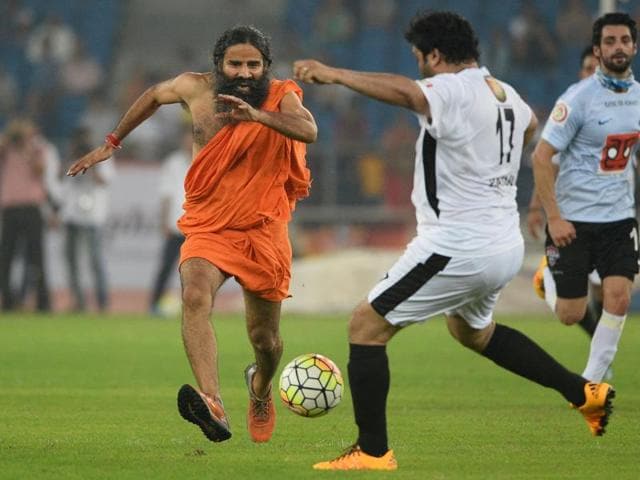 Baba Ramdev with MPs during a charitable football match between Bollywood actors and parliamentarians in New Delhi on Sunday.(Vipin Kumar/HT Photo)