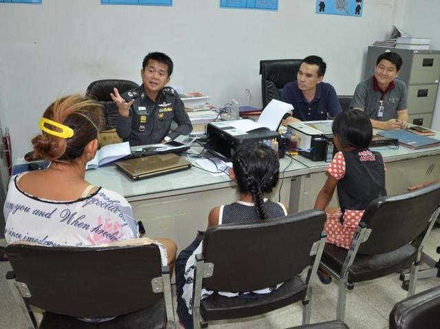 A policeman speaks to two eight-year-old girls after they tore voter lists off a wall because they liked the pink paper it was printed on, in Bangkok. (Reuters) A policeman speaks to two eight-year-old girls after they tore voter lists off a wall because they liked the pink paper it was printed on, in Bangkok. (Reuters)