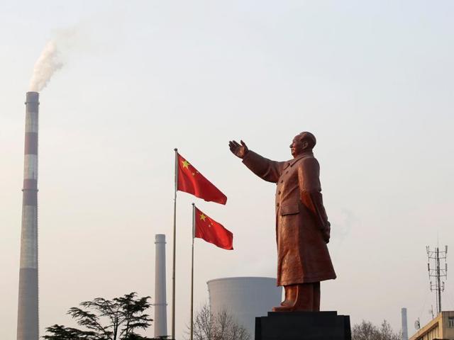 A statue of former Chinese leader Mao Zedong is seen in front of smoking chimneys in Wuhan, Hubei province. China’s Communist Party controls Xinhua, the controversial news agency accused of espionage and propaganda.(REUTERS) A statue of former Chinese leader Mao Zedong is seen in front of smoking chimneys in Wuhan, Hubei province. China’s Communist Party controls Xinhua, the controversial news agency accused of espionage and propaganda.(REUTERS)