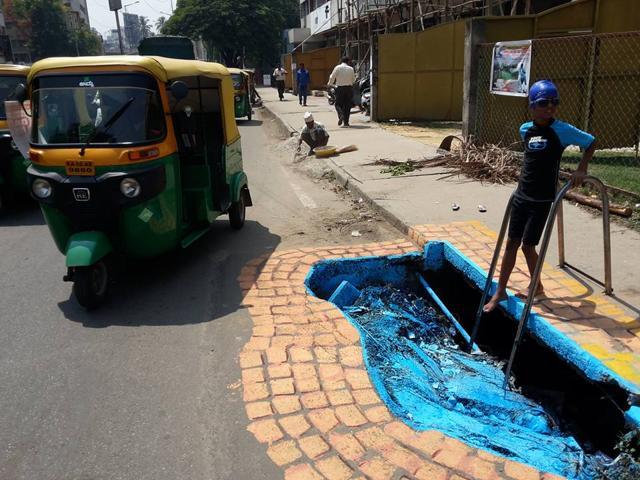 A ‘swimming pool’ created by the artist on the roadside. “I am an artist and this is a small way of contributing to the betterment of society,” he said. (Photo: Baadal Nanjundaswamy’s Facebook page) A ‘swimming pool’ created by the artist on the roadside. “I am an artist and this is a small way of contributing to the betterment of society,” he said. (Photo: Baadal Nanjundaswamy’s Facebook page)
