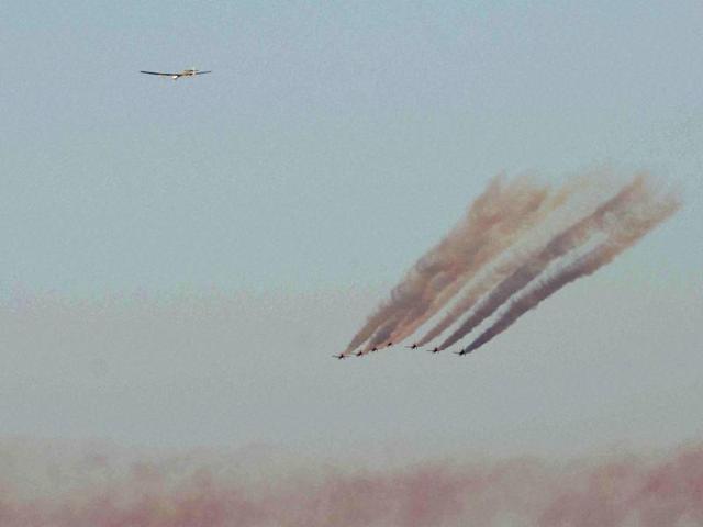 The Spanish air force aerobatic team Patrulla Aguila sends coloured smoke out while escorting the Solar Impulse 2 plane towards the San Pablo airport in Seville, Spain on June 23, 2016. (AP) 