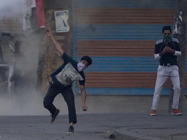 A masked Kashmiri protester throws a stone at policemen during a protest in Srinagar, Kashmir. (AP Photo) A masked Kashmiri protester throws a stone at policemen during a protest in Srinagar, Kashmir. (AP Photo)