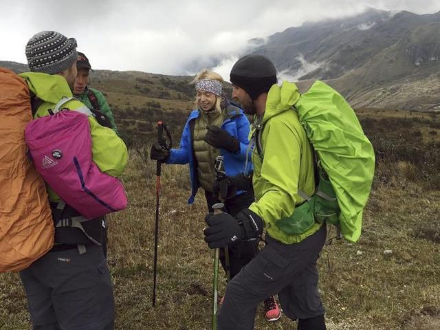 In this photo provided Monday, July 25, 2016 by the Range of Motion Project, Boston Marathon bombing survivor Adrianne Haslet, second from right, climbs Ecuador's Volcan Cayambe with a team of climbers and a guide. (AP Photo)
