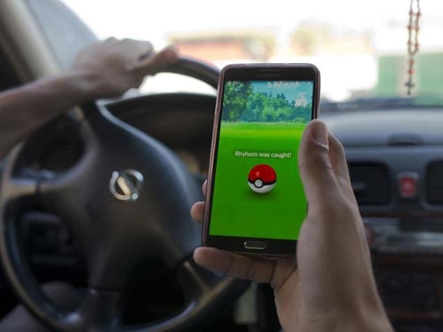 In this photo, Egyptian dentist Mark Shehata, 24, plays the geo-location-based app while driving in Cairo. Hamdi Bakheet, a member of the defence and national security committee in the Egyptian parliament said, Pokémon Go is the “latest tool used by spy agencies in the intel war, a cunning despicable app that tries to infiltrate our communities in the most innocent way under the pretext of entertainment”. (AP) In this photo, Egyptian dentist Mark Shehata, 24, plays the geo-location-based app while driving in Cairo. Hamdi Bakheet, a member of the defence and national security committee in the Egyptian parliament said, Pokémon Go is the “latest tool used by spy agencies in the intel war, a cunning despicable app that tries to infiltrate our communities in the most innocent way under the pretext of entertainment”. (AP)