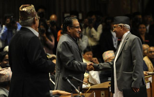 KP Oli Sharma (R) and Maoist Chairman Pushpa Kamal Dahal, known as Prachanda, (C-L) shake hands during a Parliament session in Kathmandu. (AFP) KP Oli Sharma (R) and Maoist Chairman Pushpa Kamal Dahal, known as Prachanda, (C-L) shake hands during a Parliament session in Kathmandu. (AFP)
