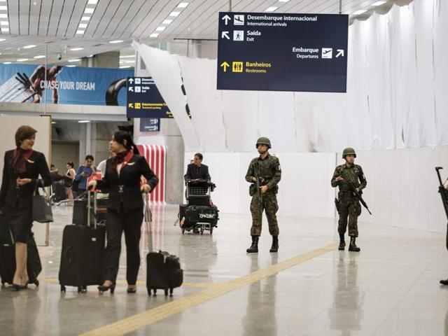 Brazilian Air Force personnel stand guard at the arrival level of the Galeao International airport. (AFP Photo)