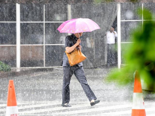A woman walks in the rain at the Parliament House in New Delhi. (Sonu Mehta/HT Photo)