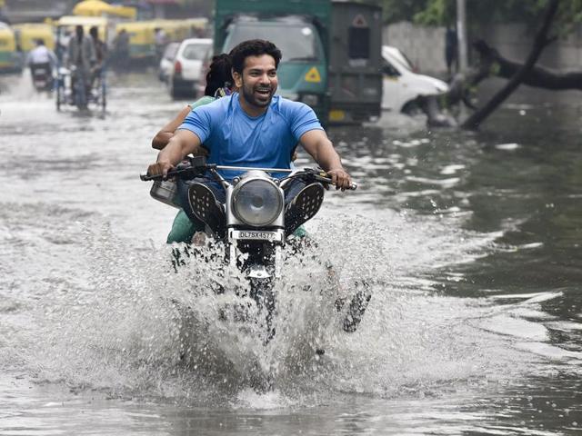 Waterlogged roads at IP Extention near Mandawali, after heavy rains dropped temperatures and provided relief from the heat, in Delhi. (Raj K Raj/HT Photo)