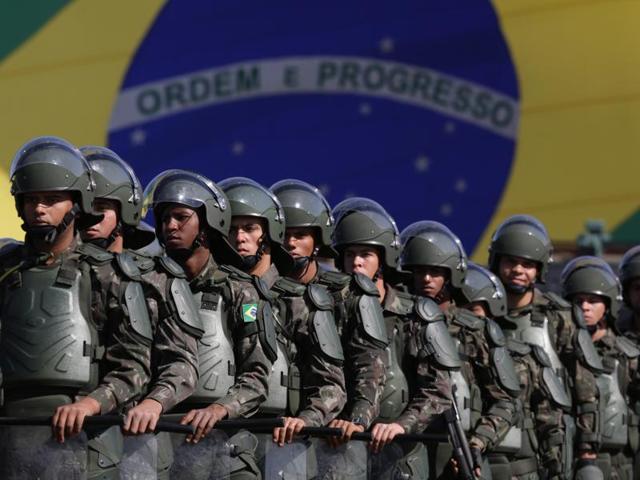Brazilian Army soldiers take part in military exercise during presentation of the security forces for the Rio 2016 Olympic Games. (AP Photo)