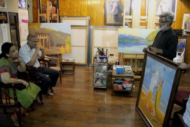 Vasudeo Kamath (right) presents his paintings to Vikas Gupta, the chief conservator of forests. (Vasudeo Kamath)