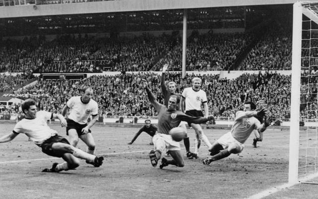 German defender Wolgang Weber (L) ties the score at 2 on a last minute shot past English defender Norbert Stiles (C) and goalkeeper Gordon Banks (R) as forward Uwe Seeler (2nd L) and defender Bobby Moore (hand raised) look on. (AFP) German defender Wolgang Weber (L) ties the score at 2 on a last minute shot past English defender Norbert Stiles (C) and goalkeeper Gordon Banks (R) as forward Uwe Seeler (2nd L) and defender Bobby Moore (hand raised) look on. (AFP)