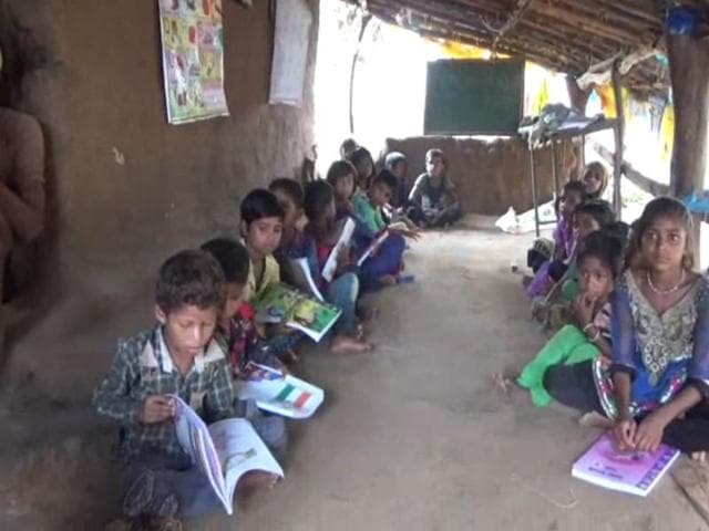 School children from classes 1 to 5 study inside the hut at village Undari of Alirajpur district on Wednesday.(HT photo)