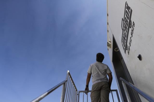 A production crew member looks up the sky to spot skydiver Luke Aikins as Aikins prepares for his skydiving attempt with a parachute in Simi Valley. (AP Photo) A production crew member looks up the sky to spot skydiver Luke Aikins as Aikins prepares for his skydiving attempt with a parachute in Simi Valley. (AP Photo)