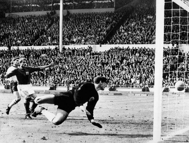 West Germany's goalkeeper Hans Tilkowski watches the ball bounce off the crossbar following a shot by English forward Geoff Hurst (not pictured) as English forward Roger Hunt (arms raised) and West Germany's defender Wolgang Weber look on during the overtime period of the World Cup final on July 30, 1966 at Wembley stadium in London. After consulting Soviet linesman Tofik Bakhramov, Swiss referee Gottfried Dienst validated the goal. (AFP) West Germany's goalkeeper Hans Tilkowski watches the ball bounce off the crossbar following a shot by English forward Geoff Hurst (not pictured) as English forward Roger Hunt (arms raised) and West Germany's defender Wolgang Weber look on during the overtime period of the World Cup final on July 30, 1966 at Wembley stadium in London. After consulting Soviet linesman Tofik Bakhramov, Swiss referee Gottfried Dienst validated the goal. (AFP)
