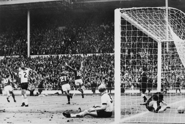 England's forward Martin Peters (16), followed by his teammate Roger Hunt, celebrates after scoring the go-ahead goal (2-1) for his team as West Germany's goalkeeper Hans Tilkowski and defender Karl-Heinz Schnellinger are down. (AFP) England's forward Martin Peters (16), followed by his teammate Roger Hunt, celebrates after scoring the go-ahead goal (2-1) for his team as West Germany's goalkeeper Hans Tilkowski and defender Karl-Heinz Schnellinger are down. (AFP)