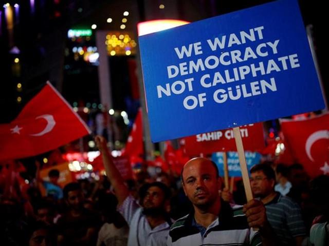 A man holds a banner as he and others have gathered in solidarity night after night since the July 15 coup attempt in central Ankara, Turkey, July 27, 2016.(Reuters Photo)