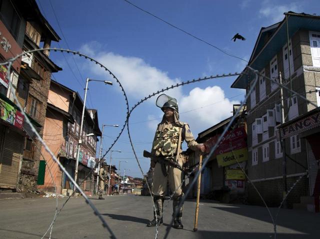 A paramilitary soldier stands guard near a temporary checkpoint during curfew in Srinagar. (AP) A paramilitary soldier stands guard near a temporary checkpoint during curfew in Srinagar. (AP)