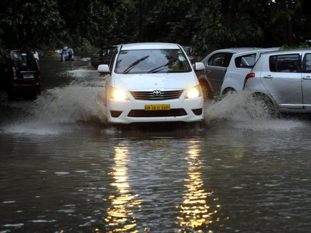 A car wades through a flooded Gurgaon road on Friday. (Abhinav Saha/ HT Photo) A car wades through a flooded Gurgaon road on Friday. (Abhinav Saha/ HT Photo)