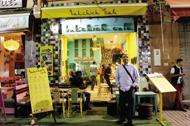 Bakshish Dean standing in front of ‘Bakchich Cafe’ in Marrakech