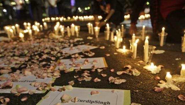 Activists light candles around posters with the names of death row inmates awaiting executions, including that of India’s Gurdip Singh, during a vigil against death penalty outside ‘the presidential palace in Jakarta. (AP Photo)