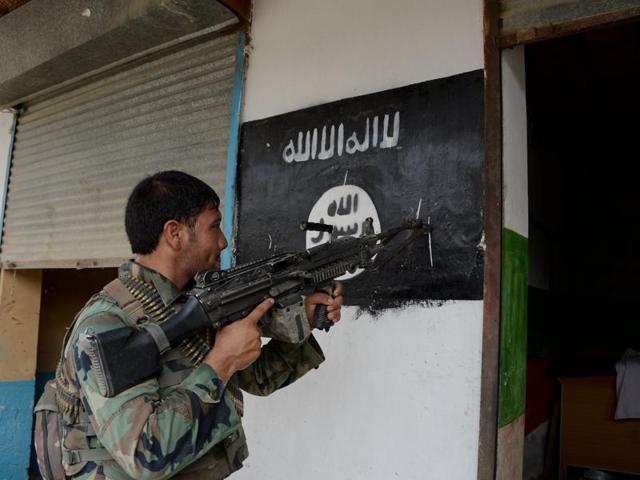 An Afghan soldier points his gun at an Islamic State banner as he patrols during ongoing clashes in Kot district in eastern Nangarhar province. (AFP File Photo) An Afghan soldier points his gun at an Islamic State banner as he patrols during ongoing clashes in Kot district in eastern Nangarhar province. (AFP File Photo)