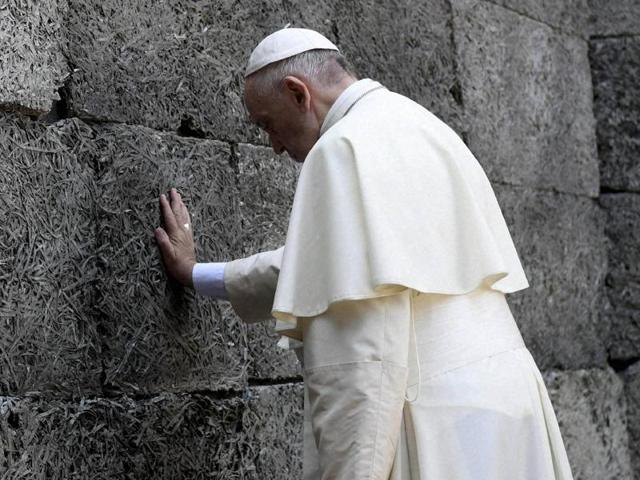 Pope Francis walks through a gate with the words "Arbeit macht frei" (Work sets you free) at the former Nazi German concentration and extermination camp Auschwitz-Birkenau in Oswiecim, Poland on Friday. (Reuters) Pope Francis walks through a gate with the words "Arbeit macht frei" (Work sets you free) at the former Nazi German concentration and extermination camp Auschwitz-Birkenau in Oswiecim, Poland on Friday. (Reuters)