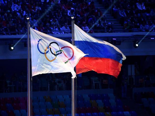 An Olympic Games flag and a Russian flag wave during the closing ceremony of the winter Olympics in Sochi. (AFP File Photo) An Olympic Games flag and a Russian flag wave during the closing ceremony of the winter Olympics in Sochi. (AFP File Photo)