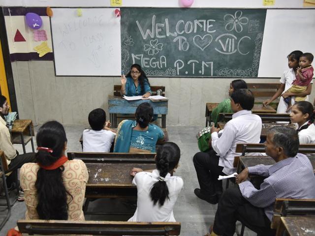 A teacher interacts with parents of schoolchildren at the Veer Savarkar Government Sarvodaya Kanya Vidyalaya in Kalkaji on Saturday. The parent-teacher meeting at government schools in Delhi will be held twice a year to make parents “part of the several initiatives being taken by the Aam Aadmi Party government”. (S BURMAULA/HT PHOTO) A teacher interacts with parents of schoolchildren at the Veer Savarkar Government Sarvodaya Kanya Vidyalaya in Kalkaji on Saturday. The parent-teacher meeting at government schools in Delhi will be held twice a year to make parents “part of the several initiatives being taken by the Aam Aadmi Party government”. (S BURMAULA/HT PHOTO)