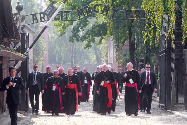 Cardinals and bishops walk through the gate of the former Nazi German death camp of Auschwitz in Oswiecim, Poland on Friday. (AP) Cardinals and bishops walk through the gate of the former Nazi German death camp of Auschwitz in Oswiecim, Poland on Friday. (AP)