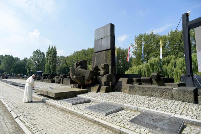 Pope Francis prays in front of the Memorial at the former Nazi Death Camp Auschwitz-Birkenau in Oswiecim, Poland on Friday. (AP) Pope Francis prays in front of the Memorial at the former Nazi Death Camp Auschwitz-Birkenau in Oswiecim, Poland on Friday. (AP)