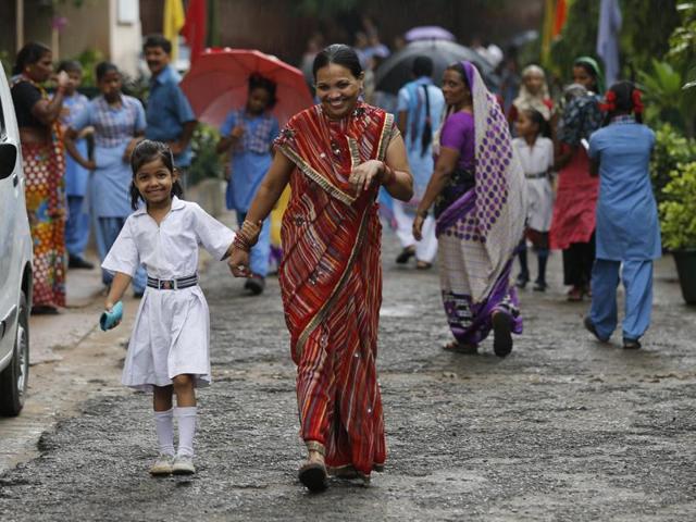 Some parents said they took leave from work to make sure they met the teachers of their children at government schools. A mother walks with her daughter to the Sarvoday Kanya Vidyalaya in West Patel Nagar for the parent-teacher meeting. (Sanchit Khanna/HT Photo) Some parents said they took leave from work to make sure they met the teachers of their children at government schools. A mother walks with her daughter to the Sarvoday Kanya Vidyalaya in West Patel Nagar for the parent-teacher meeting. (Sanchit Khanna/HT Photo)
