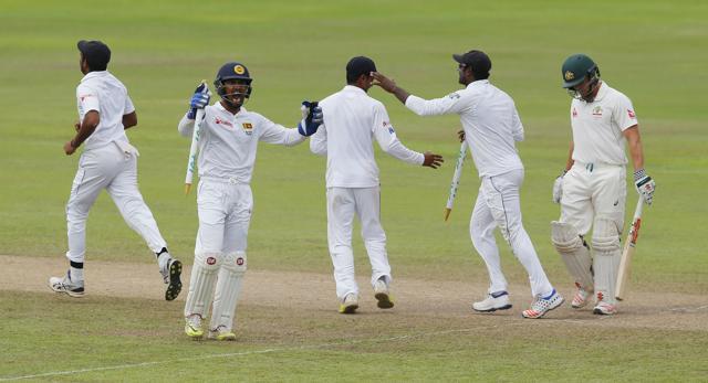 Australia's Steve O' Keefe, right, leaves the field as Sri Lankan team members celebrate their teams' victory by 106 runs in their first test cricket match in Pallekele. (AP Photo) Australia's Steve O' Keefe, right, leaves the field as Sri Lankan team members celebrate their teams' victory by 106 runs in their first test cricket match in Pallekele. (AP Photo)