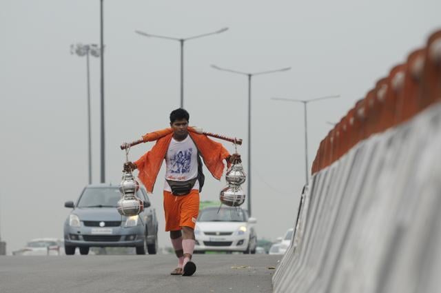 A Hindu pilgrim known as Kanwaria carrying holy water in New Delhi collected from river Ganges to be offered to local Shiva temple. (Burhaan Kinu / HT File Photo ) A Hindu pilgrim known as Kanwaria carrying holy water in New Delhi collected from river Ganges to be offered to local Shiva temple. (Burhaan Kinu / HT File Photo )