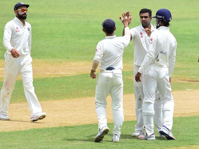 FIVE-STAR SHOW: Ashwin celebrates his fifth wicket with teammates (45th over) after Jason Holder was caught by KL Rahul . (AFP) FIVE-STAR SHOW: Ashwin celebrates his fifth wicket with teammates (45th over) after Jason Holder was caught by KL Rahul . (AFP)