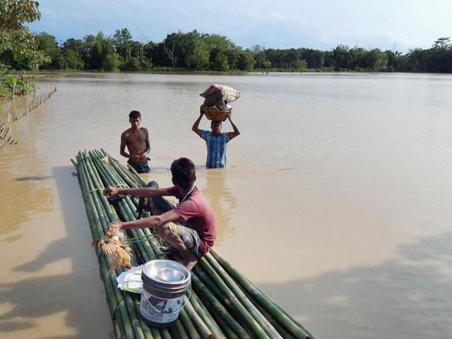 People shift to safe places from a flooded locality in Dharmanagar, North Tripura in this May 11 file photo. Months of heavy rains have battered the northeastern state badly. (PTI) People shift to safe places from a flooded locality in Dharmanagar, North Tripura in this May 11 file photo. Months of heavy rains have battered the northeastern state badly. (PTI)