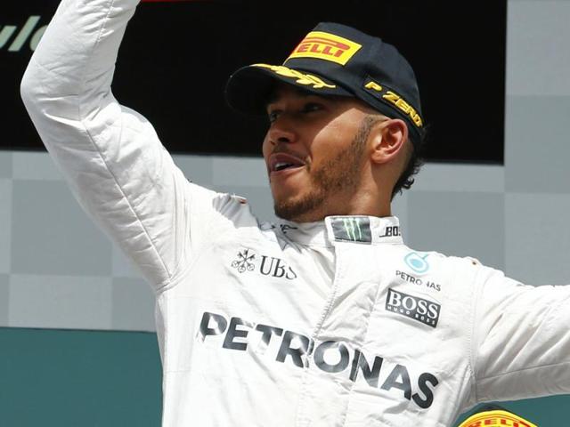 Lewis Hamilton looks on in the paddock ahead of the Hockenheim circuit.(AFP Photo)
