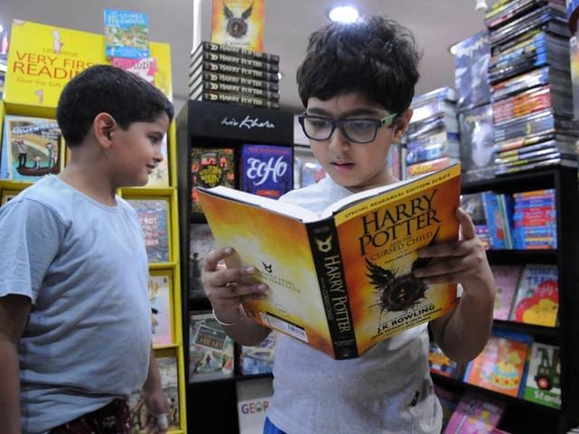 A boy reads the Harry Potter and the Cursed Child in Kool-S-Kool book store in Qutub Plaza Market in DLF Phase-1. (Parveen Kumar/HT Photo)