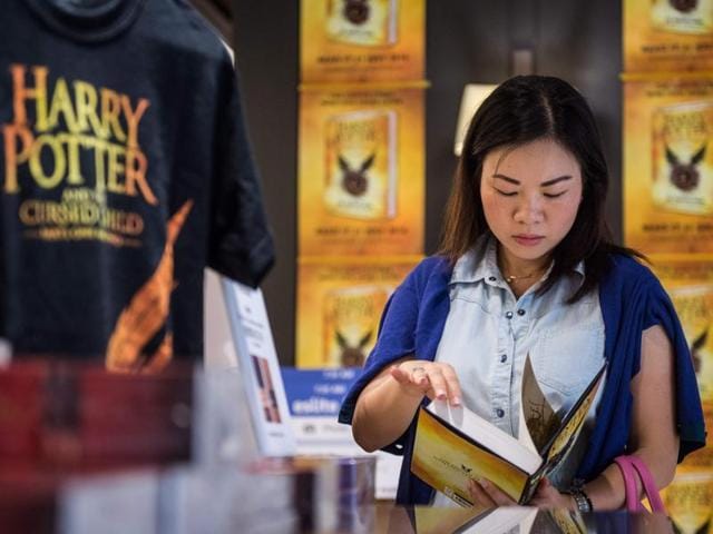 A customer with a copy of the latest Harry Potter book in Hong Kong on Sunday. (AFP) A customer with a copy of the latest Harry Potter book in Hong Kong on Sunday. (AFP)