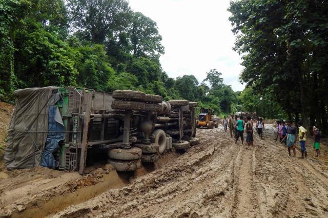 Indian truck drivers and assistants are joined by others as they look at an overturned truck stuck in mud on National Highway 44 (NH-44) at Khasiapunji, some 205km north of Agartala on the border of the north-eastern states of Assam and Tripura, on July 6, 2016. (AFP) Indian truck drivers and assistants are joined by others as they look at an overturned truck stuck in mud on National Highway 44 (NH-44) at Khasiapunji, some 205km north of Agartala on the border of the north-eastern states of Assam and Tripura, on July 6, 2016. (AFP)
